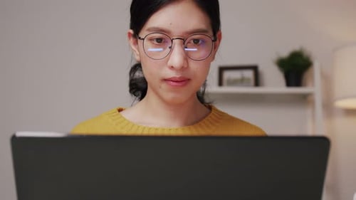 Young Woman Working at Home on Laptop