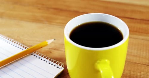 Coffee, Notepad, and Pencil on Desk