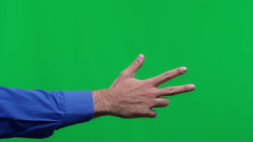 Male Hand Showes Three Fingers on Isolated Green Background