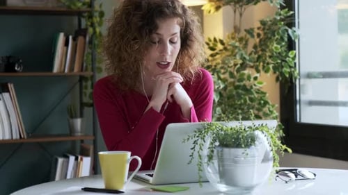 Woman on Laptop Video Call at Home