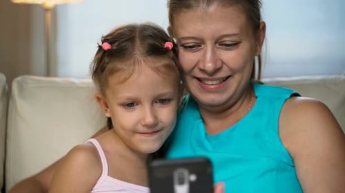 Mother and Daughter Using Mobile Phone Together