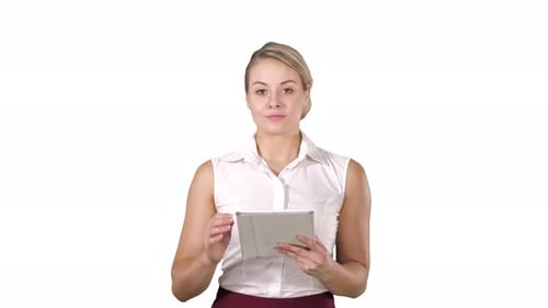Beautiful Girl Holding a Tablet Touch Pad Computer Gadget Swiping Pages and Looking in Camera on