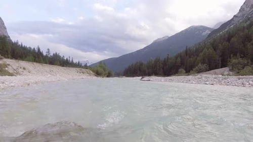 Aerial Flight Above River Creek with Woods and Rocks in Sunny Day