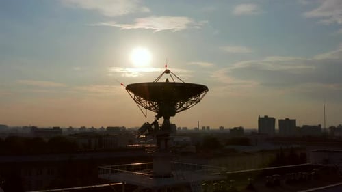 Satellite Dish in Urban Setting at Sunset