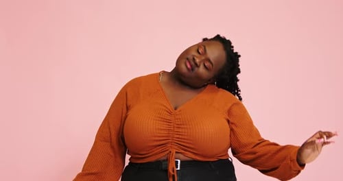 AfricanAmerican Plus Size Model Dances Looking Into Camera