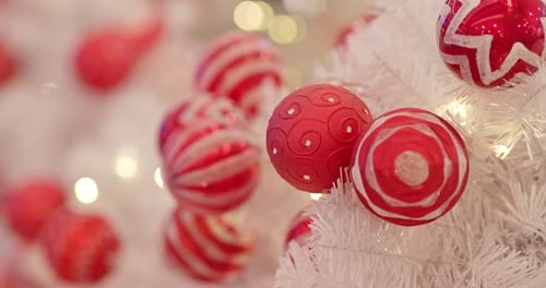 Red Ornaments on White Christmas Tree Decorations Close Up