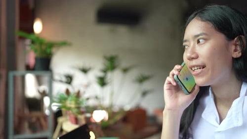 Woman Talks on Cell Phone Indoors