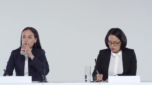 Two Businesswomen Speaking at a Corporate Event