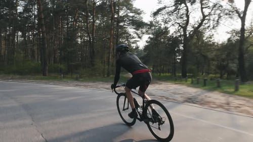 Strong cyclist or triathlete cycling in park