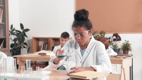 Girl Doing Science Experiment in Classroom