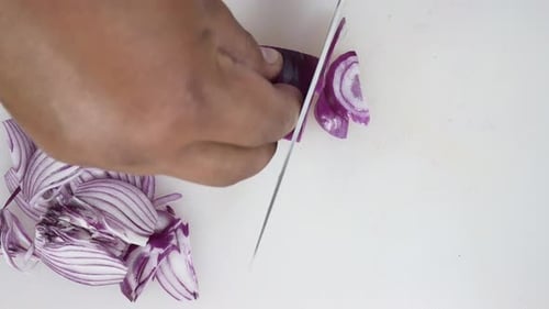 Close up of chief man making salad healthy food and chopping onion on cutting board