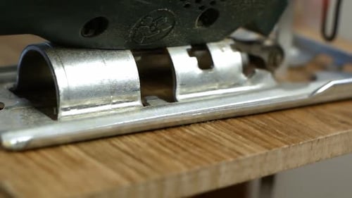 Electric Jigsaw Cutting Through Wood Close-up