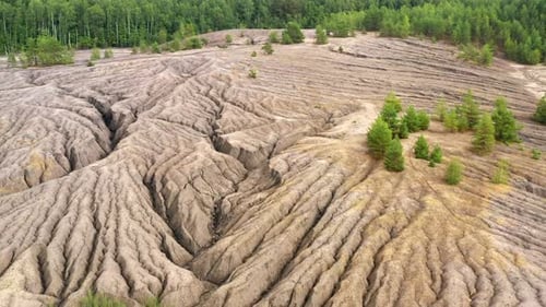 Aerial view of abandoned quarry with canyons and cracks.
