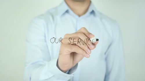 Man Writes Our Services on Clear Surface