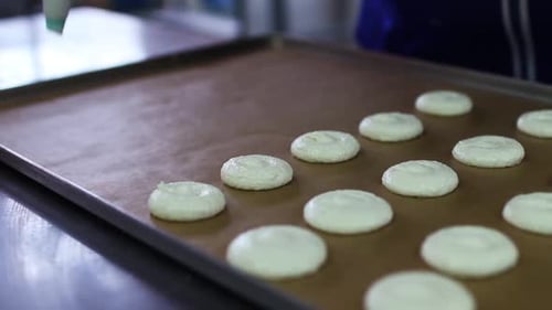 Chef Piping Cookie Dough onto Baking Sheet
