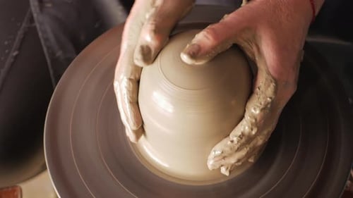An Elderly Woman Senior Professional Potter in Workshop Makes Jug Out of Clay