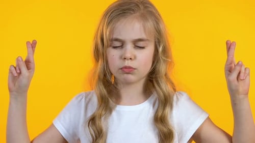 Little Girl Crossing Fingers and Making Wish, Strong Desire, Childish Naivety