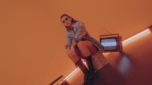 Stylish Woman Posing with Retro Television