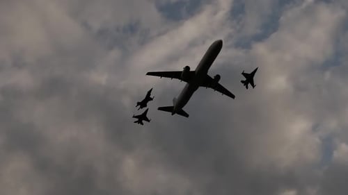Airplane with Fighter Jets Flying in Formation Silhouette