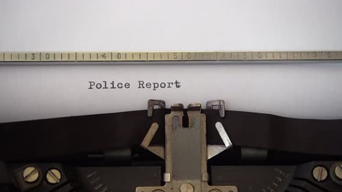 Typing phrase Police Report on retro typewriter. Close up.