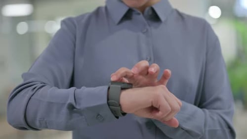 Close Up of Hands of Indian Woman Using Smart Watch