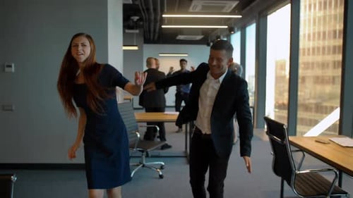 Colleagues Dance Together in Modern Office Space