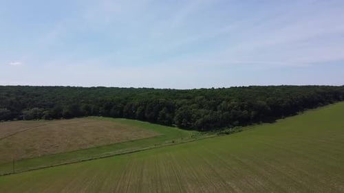 Aerial drone view of a flying over the rural agricultural landscape.