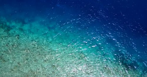 Wide angle above island view of a white paradise beach and blue ocean background in colorful