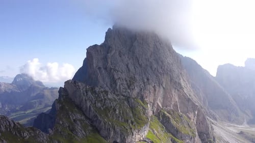 Aerial View of Tranquil Clouds and Fog Hugging Seceda's Mountaintop