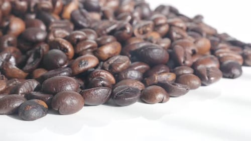 Highest quality coffee beans on pile 4K tilting footage