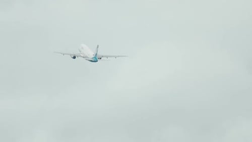 Airplane Ascending into the Clouds in the Sky