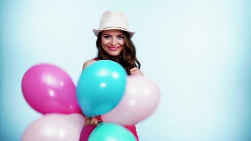 Joyful Woman with Colorful Balloons Laughing and Smiling