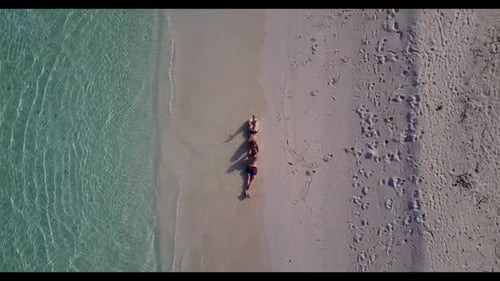 Man and lady engaged on exotic sea view beach adventure by blue sea with white sandy background of t