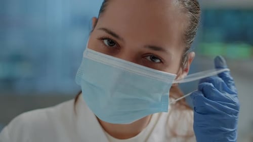 Chemistry Engineer Taking Off Face Mask in Science Laboratory