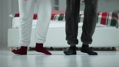 Figures in Pajamas Dancing in a Bedroom