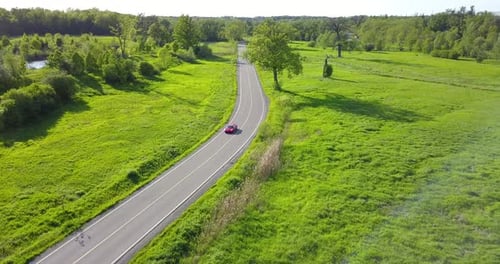 Aerial footage of Red Ferrari on the Road