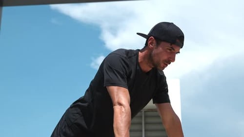 Muscular Man Doing Elevated Pushups in Urban Setting