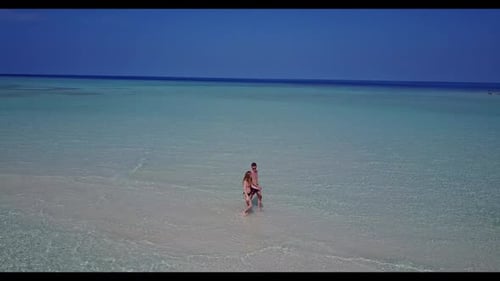 Man and woman relax on beautiful resort beach adventure by blue sea and white sandy background of th