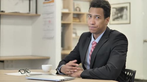 African Businessman Waving Finger to Reject at Work