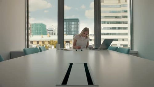 Woman Working in Bright Corporate Conference Room