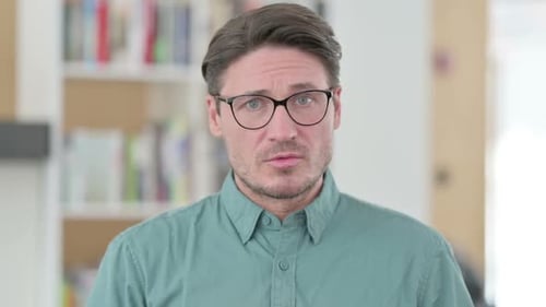 Man Shakes Head, Indicates No With Finger