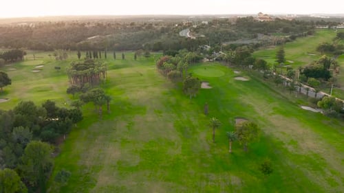 Aerial View. Empty Golf Course. Breathtaking Sunset Shining on Golf Course.