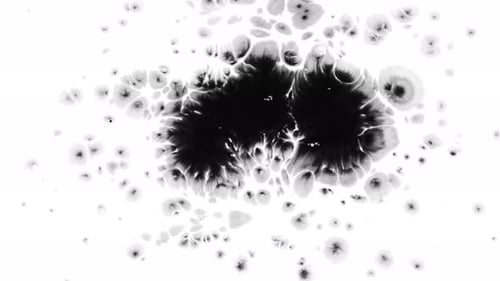 Black Ink Bloom Spreading Across White Surface
