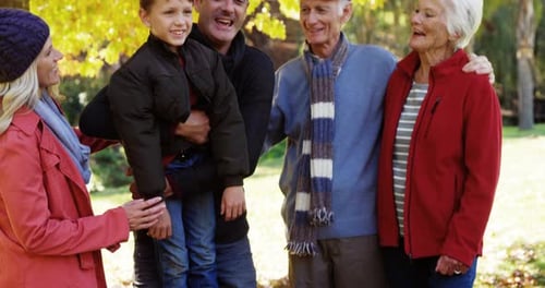 Family Group Smiling Together in Autumn Park