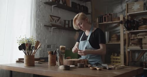 Woman Woodcarver Working with Hand Tools in Workshop