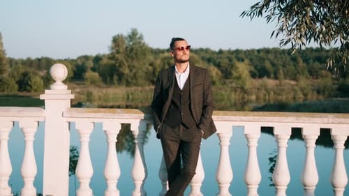 Stylish Man in Suit Posing by Lake