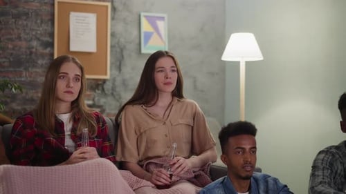 Young Adults Watching Something Shocking on TV