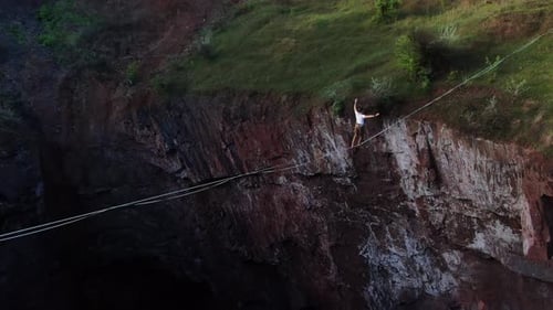 Man Walks Tightrope Over Canyon in Wilderness