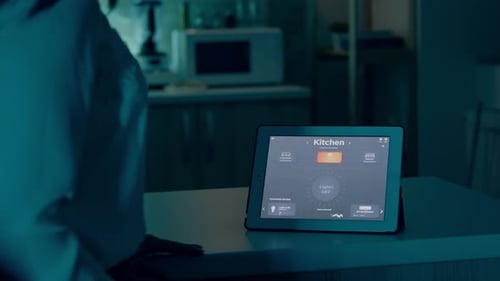 Woman Controls Smart Home Using Tablet Interface