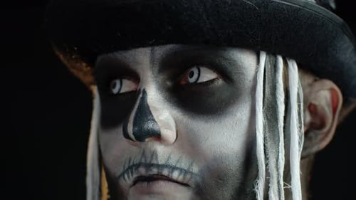 Close-up Shot of Creepy Man in Skeleton Halloween Makeup Opening Eyes and Looking Spooky at Camera